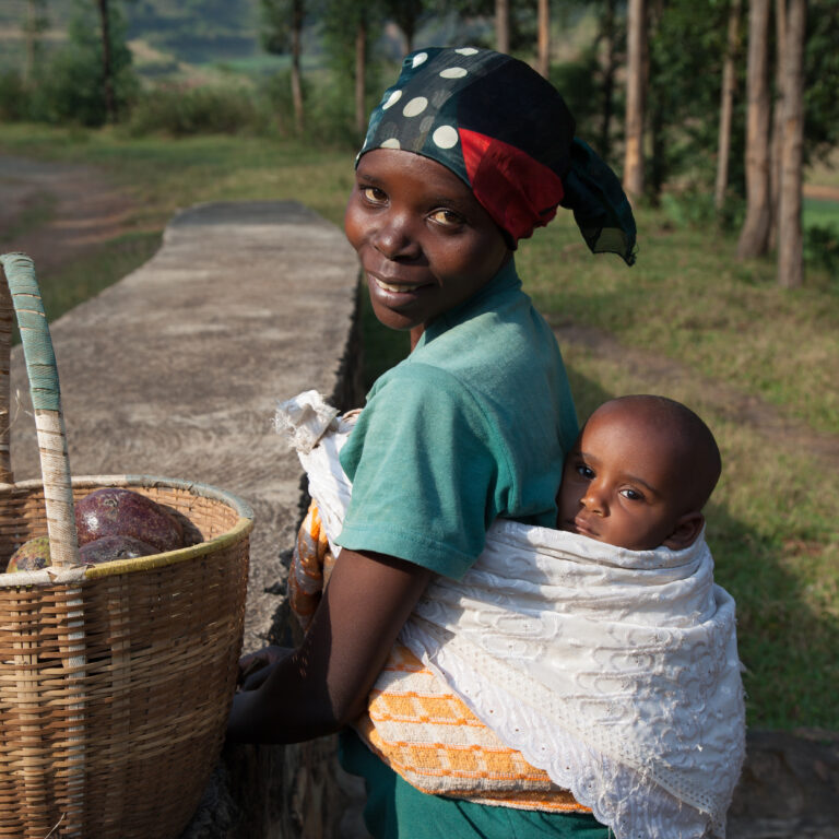 Woman in Rwanda carries her baby on her back