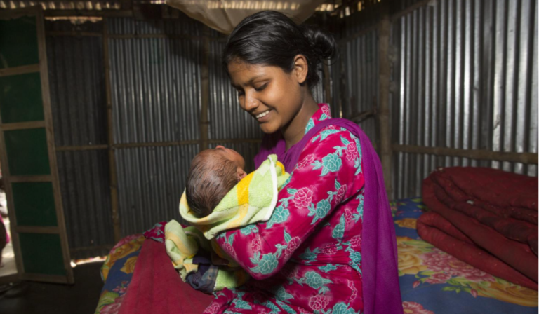 Mother in Bangladesh holding her baby. May 2021.