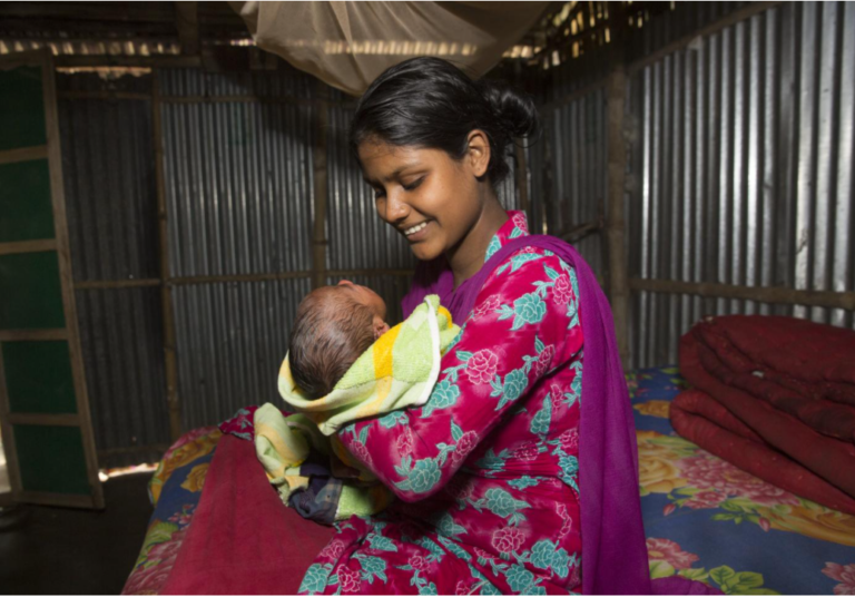 Mother in Bangladesh holding her baby. May 2021.